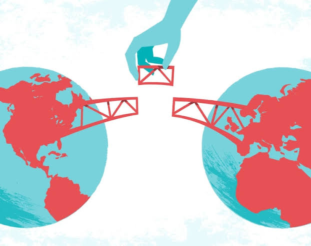 Illustration of a hand placing the final piece of a bridge connecting two globes