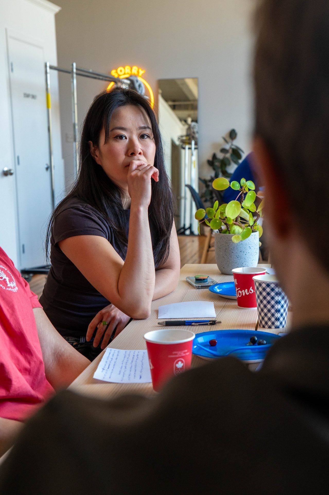 Attendee listening thoughtfully at the table